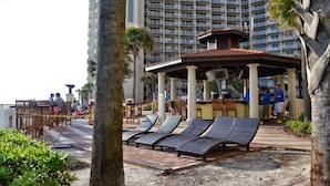 A resort with a pool area, lounge chairs, and a bar. - Shores Of Panama 621-sleeps 8, Free Beach Fun! Reserved Parking Space! 2 Bedroom Condo by RedAwning (Panama City Beach)