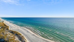 A coastal beach with clear blue waters and a sandy shore. - Emerald Beach 1830 - 2 Bedroom/2 Bath+Bunks 2 Condo by RedAwning (Panama City Beach)