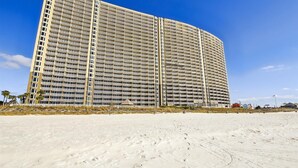 A large, multi-story hotel with a uniform facade and balconies. - Emerald Beach 1830 - 2 Bedroom/2 Bath+Bunks 2 Condo by RedAwning (Panama City Beach)