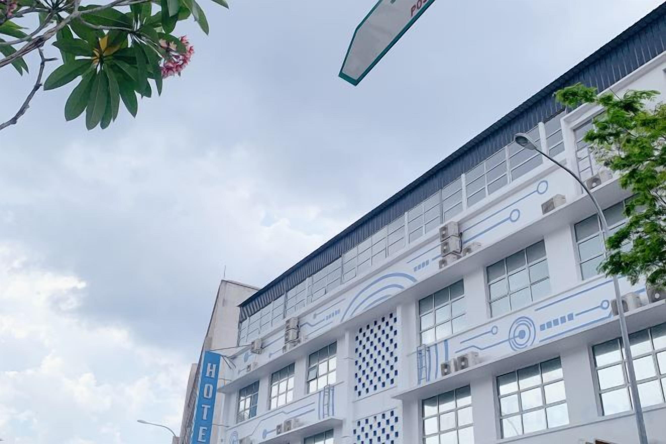 A multi-story hotel with a modern facade, large windows, and a prominent sign indicating it is a hotel.