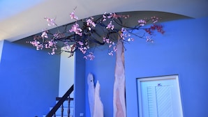 A staircase with a wooden handrail and a blue wall. - LONG LIFE B&B (Taitung)