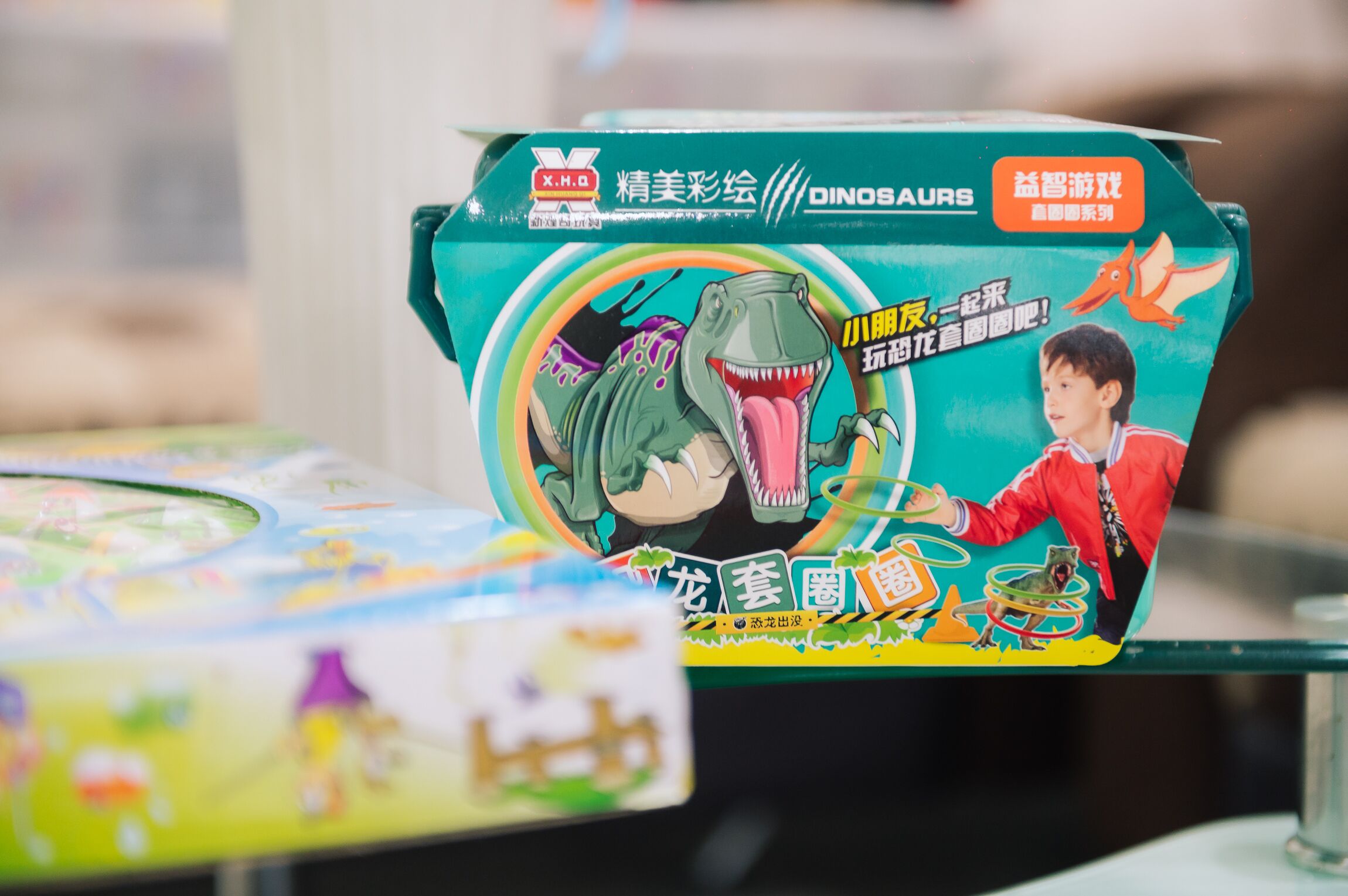 A box of a children's dinosaur-themed coloring book.