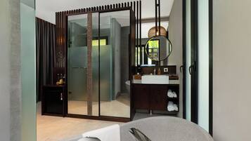 Une salle de bain moderne avec une douche à parois de verre, un meuble-lavabo avec un miroir et un lavabo rond.