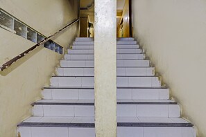 A staircase with white steps and a central column, leading upwards.