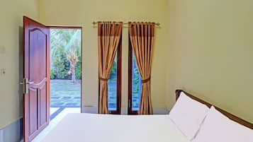 Quarto com cama, porta e cortinas.