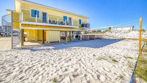 A two-story beach house with a covered patio and a fenced swimming area. - Coastal Camphouse: Gulf View Home | Private Pool, Pet Friendly, Amenities+ (Navarre)