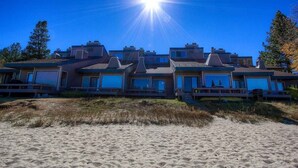 A beachfront property with multiple houses, each featuring large windows and a flat roof. - Sky Lake Splendor 5 Bedroom Condo by RedAwning (South Lake Tahoe)
