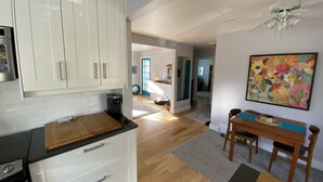 A modern kitchen with white cabinets, a wooden countertop, and a ceiling fan. - Walk to Victoria Hospital - fenced yard - quiet neighbourhood (London)