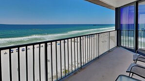 A balcony with a view of the beach and ocean. - Edgewater Windward #603 | Gulf Front + Resort Amenities (Panama City Beach)