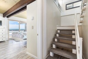 A staircase with carpeted steps leading to a balcony with a view of the sea. - Sand Dollar Beachfront Home, Direct Beach Access! (La Selva Beach)