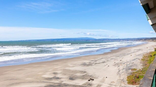 A beach with a clear view of the ocean and distant mountains. - Sand Dollar Beachfront Home, Direct Beach Access! (La Selva Beach)