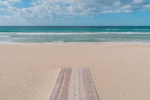 A beach with a wooden deck leading to the water. - Apartment 'Suite Buena Vista' with Sea View, Balcony and Air Conditioning (Gallipoli)