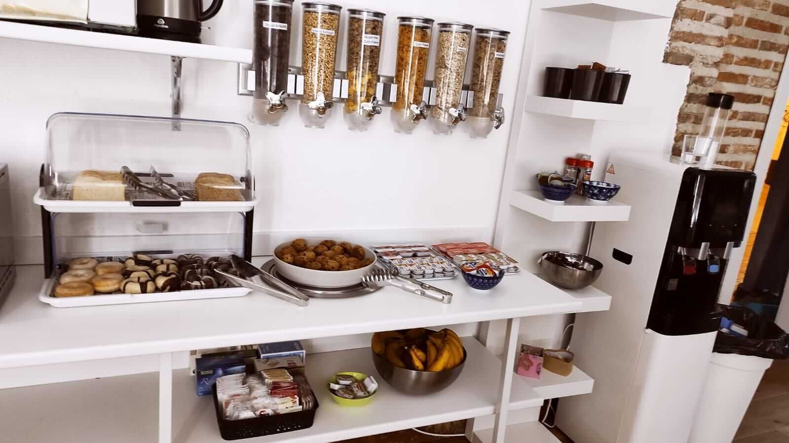 A kitchen with a white countertop, various food items, and utensils.