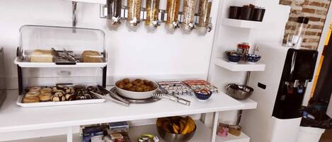 A kitchen with a white countertop, various food items, and utensils.