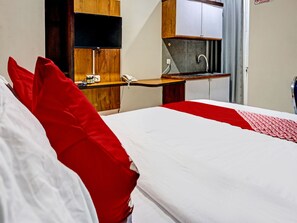 Laptop workspace, bed sheets