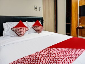 Laptop workspace, bed sheets