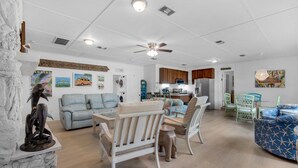A spacious living room with a dining area, a kitchen, and a laundry room. - 🏝️In the Heart of Navarre-Bungalow By the Sea-Mermaid (Navarre)