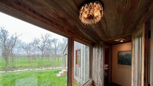 A room with large windows, a wooden ceiling, and a chandelier. - ELLINGER COUNTRY FARMHOUSE  (Columbus)