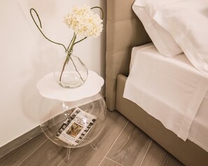 A bedroom with a bed, a bedside table with a vase of flowers, and a magazine on the floor. - C' ERA UNA VOLTA  (Assisi)