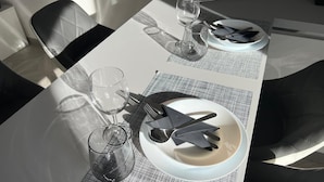 A dining table set with plates, cutlery, and glasses, with a chair partially visible. - C' ERA UNA VOLTA  (Assisi)