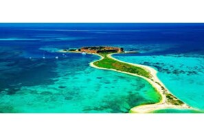 Escape to a serene island getaway with access to turquoise waters and a secluded, natural setting.