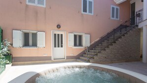A spa area with a hot tub, a staircase, and a door with shutters. - Awesome apartment in Podgrade with WiFi (Podgrade)
