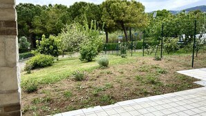 A garden with trees, a fence, and a paved area. - S287 - Sirolo, villa with garden near the centre (Sirolo)