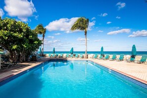 A pool area with lounge chairs and umbrellas, surrounded by palm trees and a clear view of the ocean. -
Great Value!! Oceanfront 3 bedroom condo on 7-mile beach. (George Town)