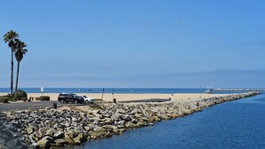A rocky shoreline with a clear view of the beach and ocean.