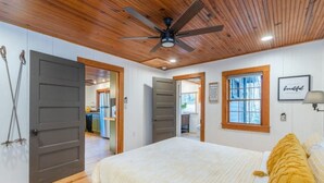 A bedroom with a bed, wooden ceiling, and a ceiling fan. - Ole Blue - Table Rock, Sassafras, Lake Keowee, Lake Jocassee. (Sunset)