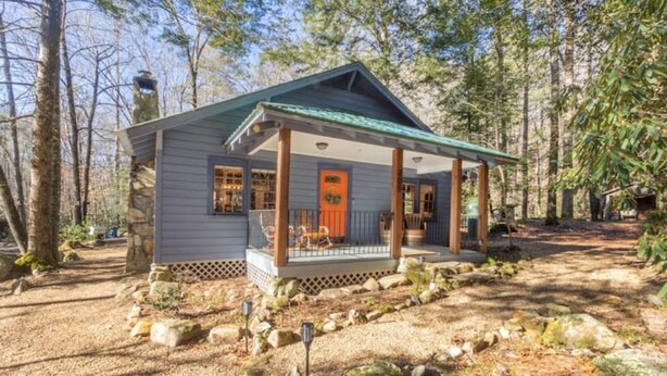 A cabin with a porch, surrounded by trees and rocks. - Ole Blue - Table Rock, Sassafras, Lake Keowee, Lake Jocassee. (Sunset)