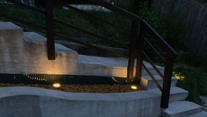 A concrete staircase with metal railings and a light fixture at the bottom. - Apartment in Mauerbach Near Vienna With Pool (Mauerbach)
