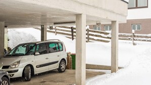 A white car parked under a concrete structure with snow on the ground. - Penthouse Apartment in Wagrain Near ski Area (Wagrain)
