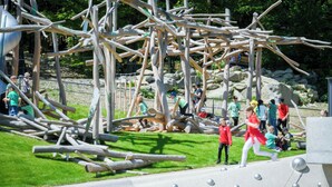 An outdoor play area with wooden structures and a paved walkway. - Apartment in Freyung Near Bavarian Forest (Freyung)