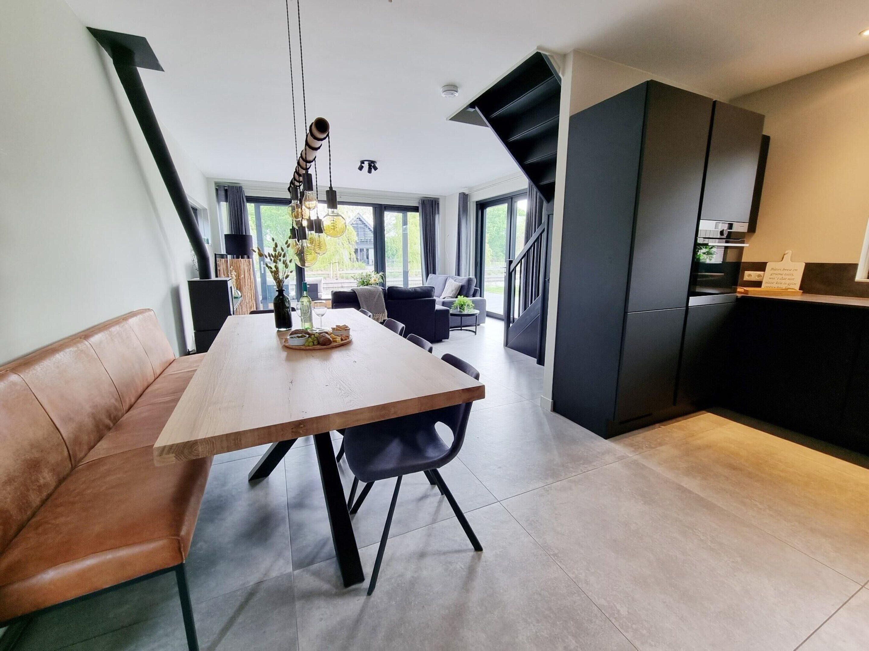 A modern kitchen with a dark countertop and a built-in oven.