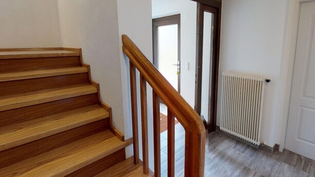 A wooden staircase with a handrail leading to a door. - Holiday Home Bodensdorf Near Ski & Lake (Steindorf am Ossiacher See)