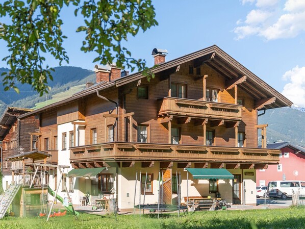 A large wooden building with multiple balconies and a covered outdoor seating area. - Apartment in Mittersill Near Ski Slopes (Mittersill)