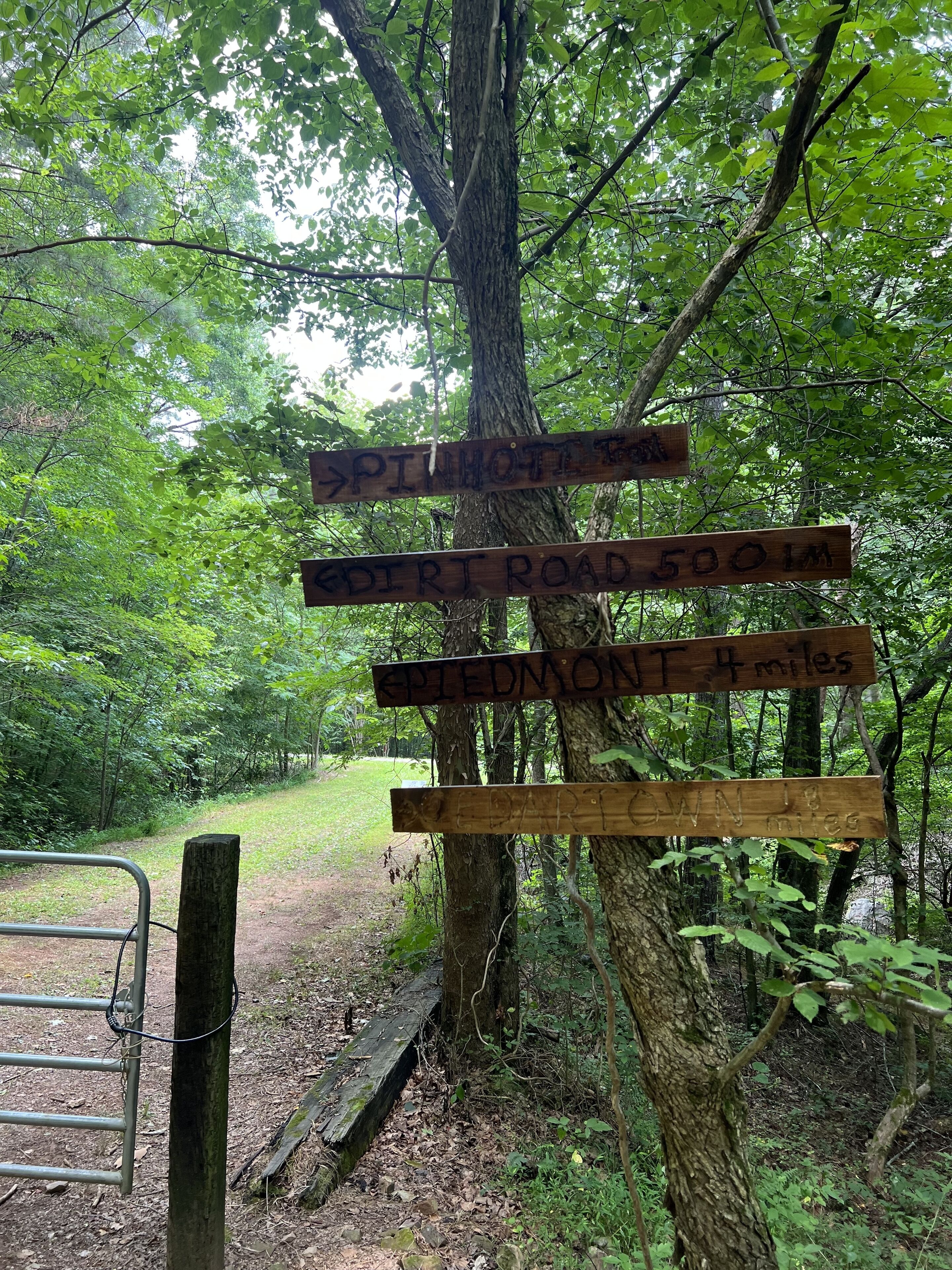 A wooden signpost with directional information for hikers.