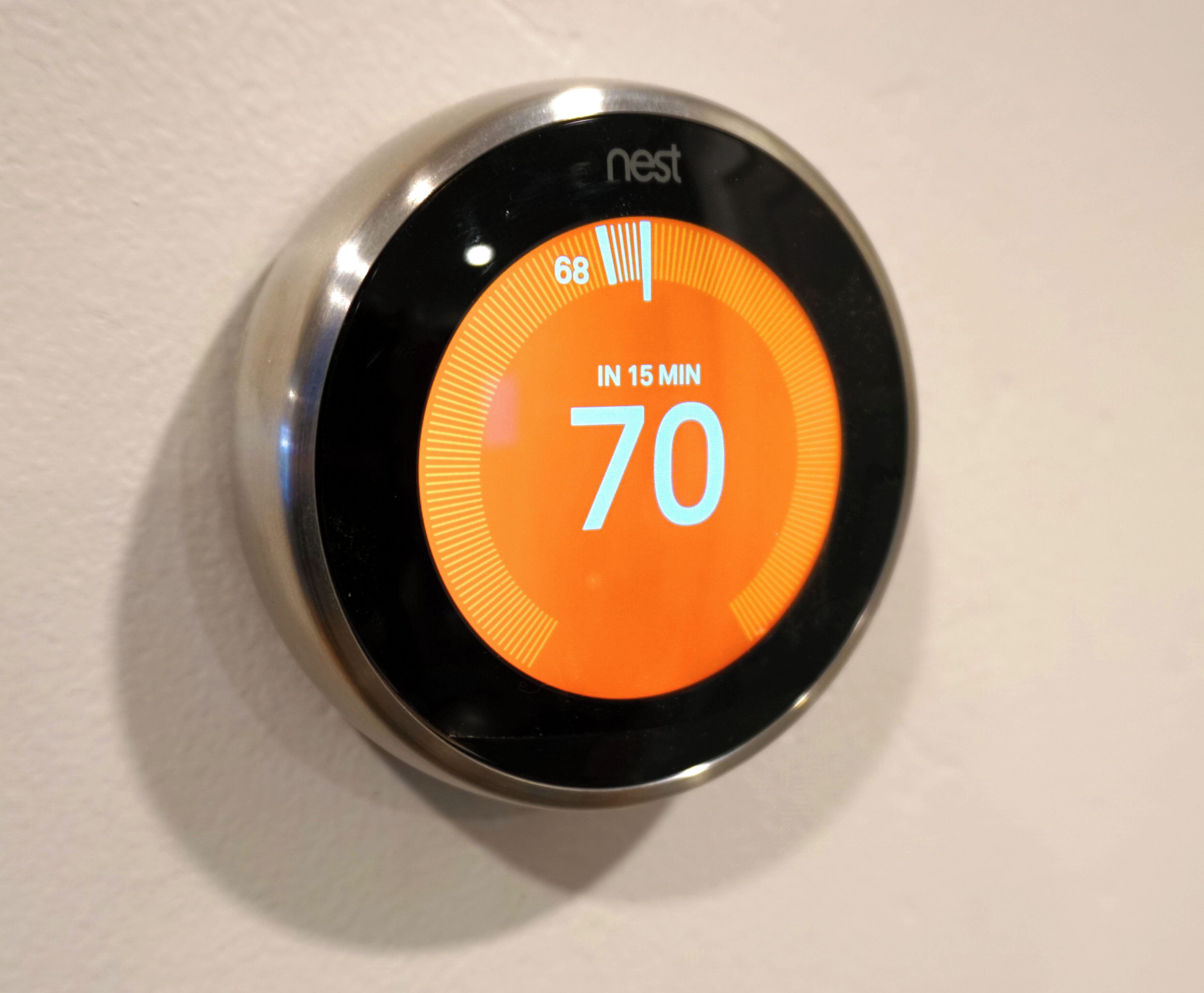 A Nest thermostat displaying a temperature of 70°F with a countdown timer of 15 minutes.