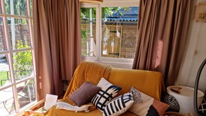 A cozy room with a bed, a window, and a view of the outdoors. - Tranquil Chalet in Geel With Garden (Geel)