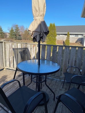 Enjoy al fresco dining on the deck with a round table and comfortable seating for four.