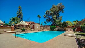 A swimming pool with lounge chairs and a small building, surrounded by trees and a clear blue sky. - Newly Remodeled, Cozy & Private Condo - Beautiful Fountain Hills - Near Fountain (Fountain Hills)