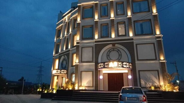 A multi-story building with a prominent entrance and illuminated signage. - HOTEL A9 BARNALA (Barnala)