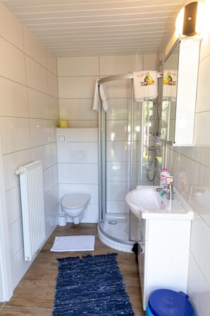 A bathroom with a shower, toilet, and sink. - Bungalow by Lake Ossiach With Mountain Views (Steindorf am Ossiacher See)