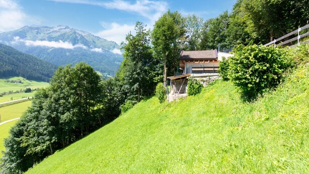 A house on a hillside with a mountain in the background. - Apartment Bramberg Near Wildkogel Ski Lift (Bramberg am Wildkogel)