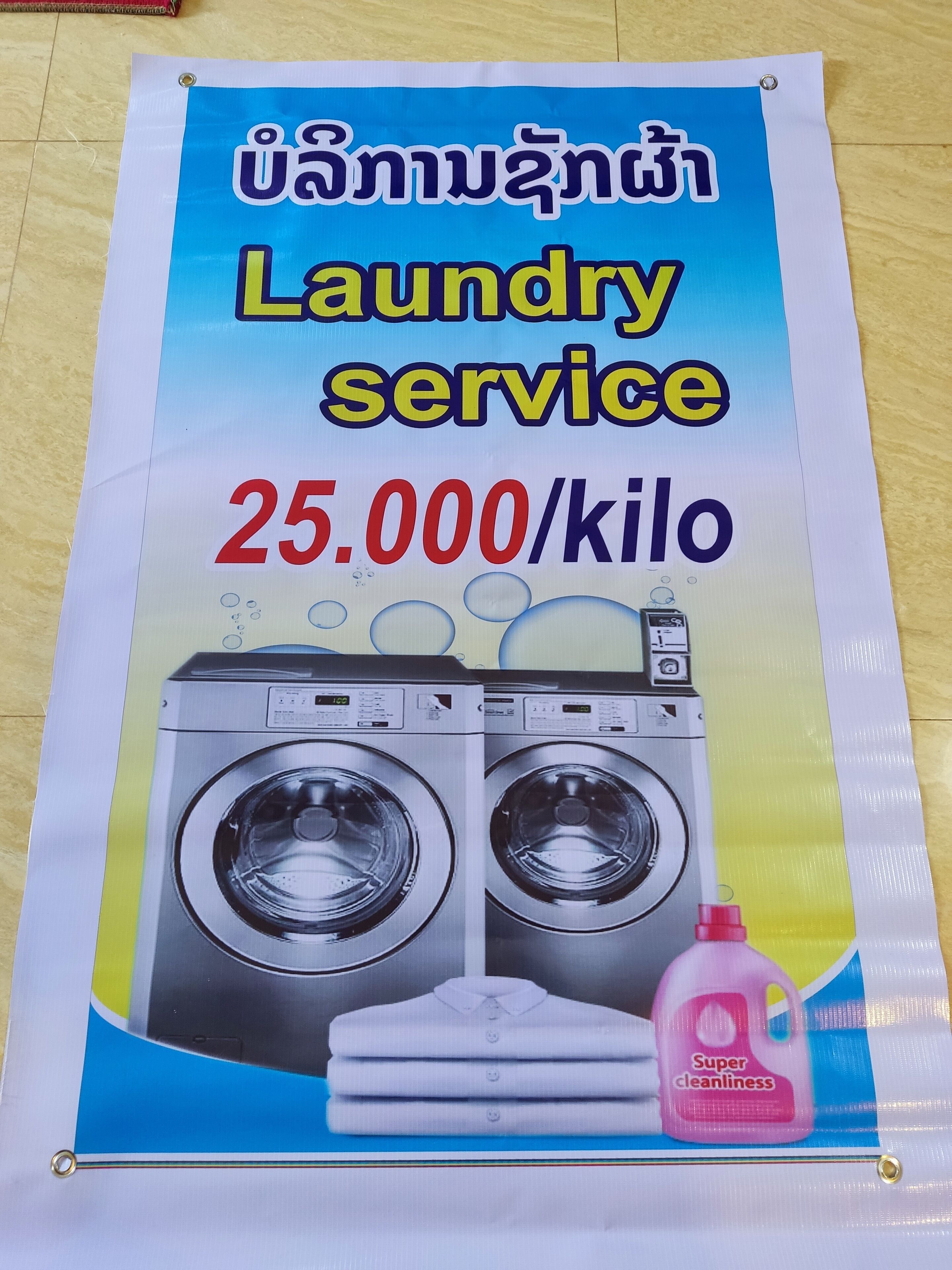 A laundry service advertisement with a price of 25,000 per kilo.