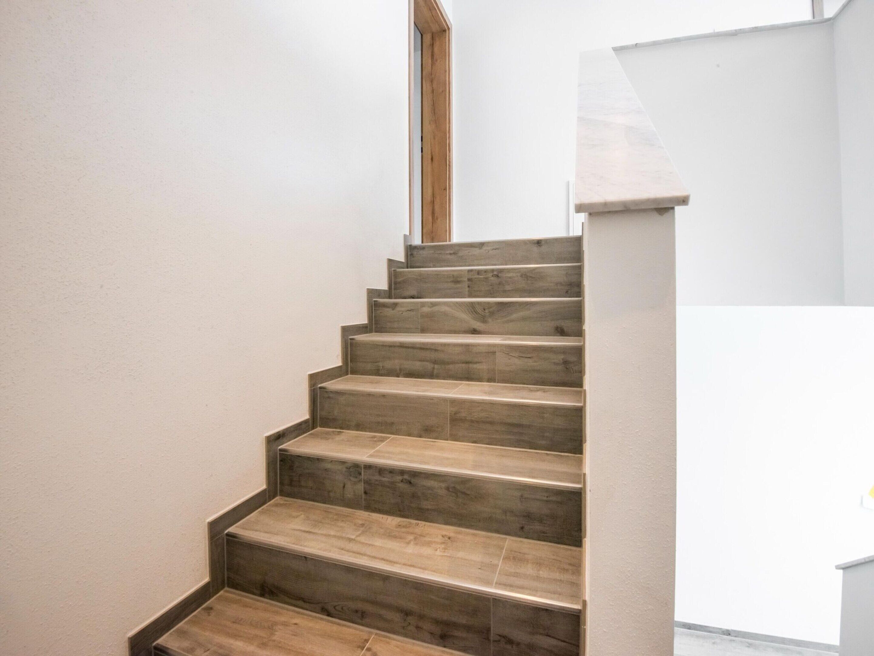 A staircase with wooden steps leading to a landing.