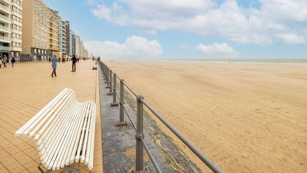 A beach promenade with a row of buildings on one side and a sandy beach on the other. - Apartment in Oostende With Balcony (Ostend)