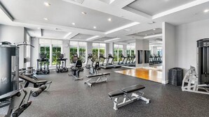 A spacious gym with treadmills, weight machines, and a mirrored wall. - Nautical Beach Suite - Casa Costa 314S - 2 Beds, Pools, Beach & Dog Friendly (Boynton Beach)