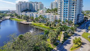A high-rise hotel with multiple floors, a waterfront view, and a well-maintained garden area. - Nautical Beach Suite - Casa Costa 314S - 2 Beds, Pools, Beach & Dog Friendly (Boynton Beach)